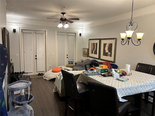 dining space featuring french doors, ceiling fan with notable chandelier, ornamental molding, and dark hardwood / wood-style flooring