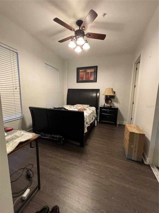 bedroom with ceiling fan and dark wood-type flooring