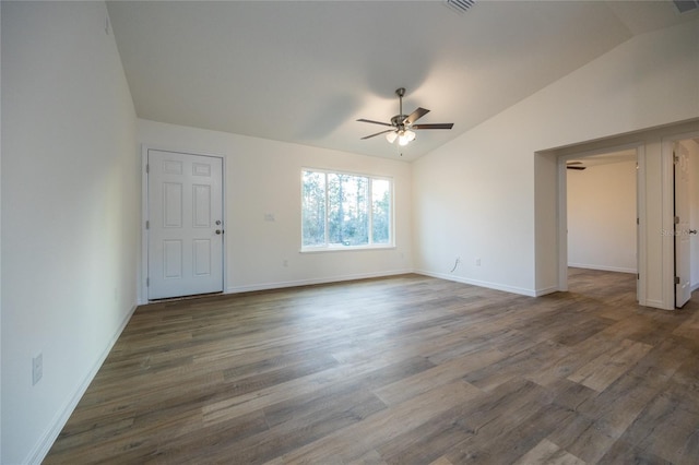 empty room featuring lofted ceiling, dark wood-type flooring, and ceiling fan