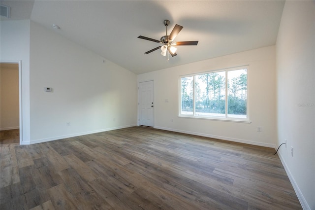 spare room with lofted ceiling, dark wood-type flooring, and ceiling fan