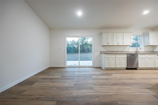 kitchen featuring white cabinetry, dishwasher, sink, and light hardwood / wood-style flooring