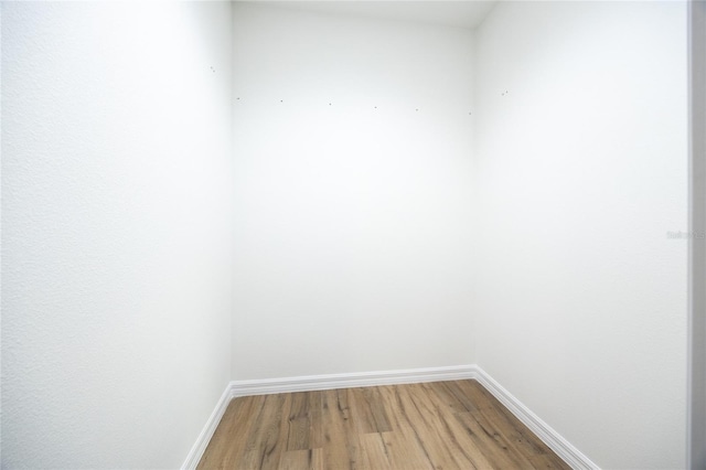 spare room featuring wood-type flooring