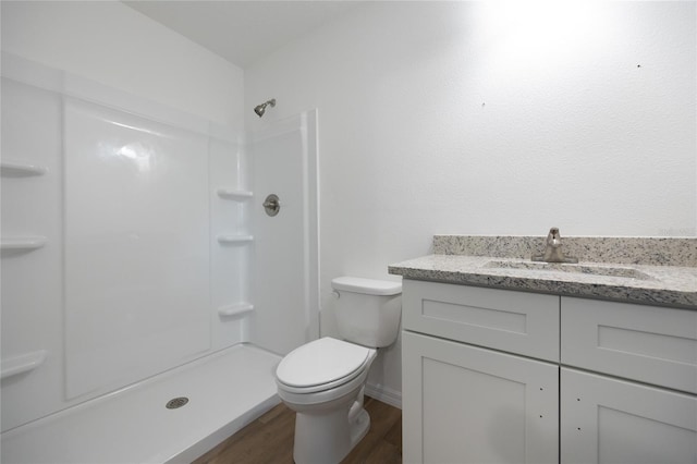 bathroom with vanity, hardwood / wood-style floors, toilet, and walk in shower