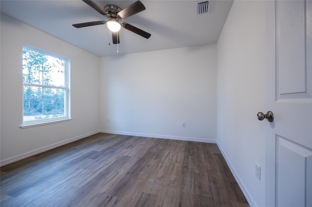 spare room with dark wood-type flooring and ceiling fan