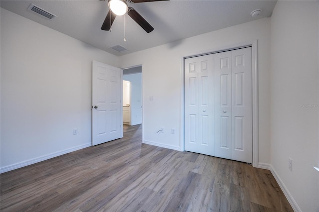 unfurnished bedroom with ceiling fan, a closet, and light hardwood / wood-style flooring