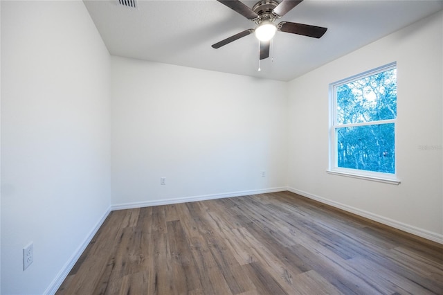 spare room with hardwood / wood-style floors and ceiling fan