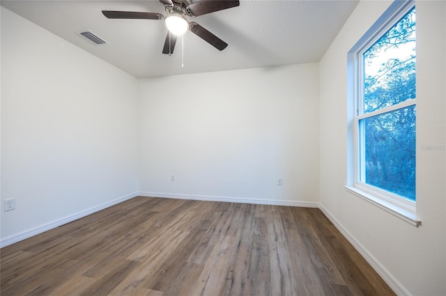 spare room with hardwood / wood-style floors and ceiling fan