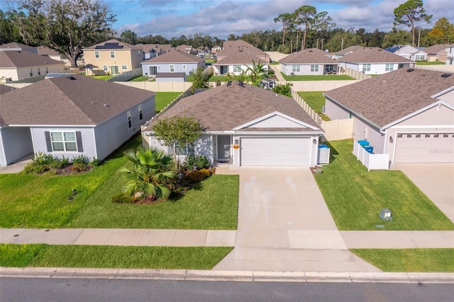 view of front of property featuring a front yard and a garage