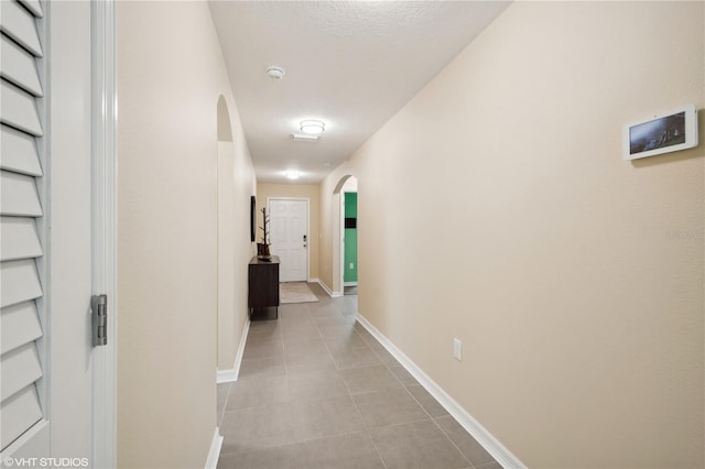 hall featuring a textured ceiling