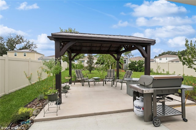 view of community featuring a gazebo, a patio area, and a lawn