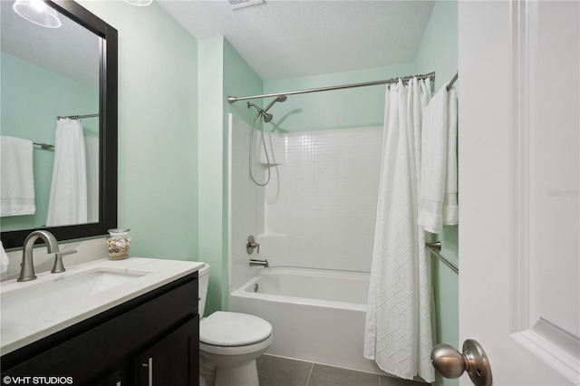 full bathroom with shower / tub combo, vanity, a textured ceiling, tile patterned floors, and toilet