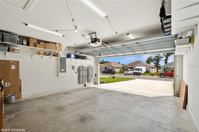 garage featuring a garage door opener and electric panel