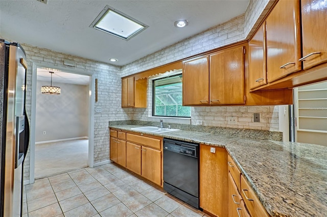 kitchen with tasteful backsplash, stainless steel fridge with ice dispenser, dishwasher, brown cabinets, and a sink