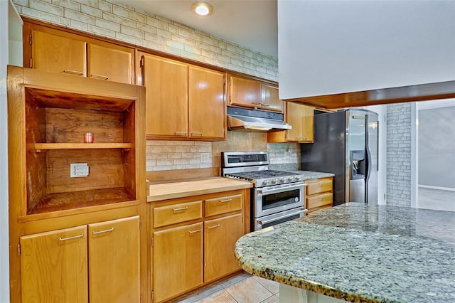 kitchen featuring under cabinet range hood, open shelves, tasteful backsplash, appliances with stainless steel finishes, and light tile patterned floors