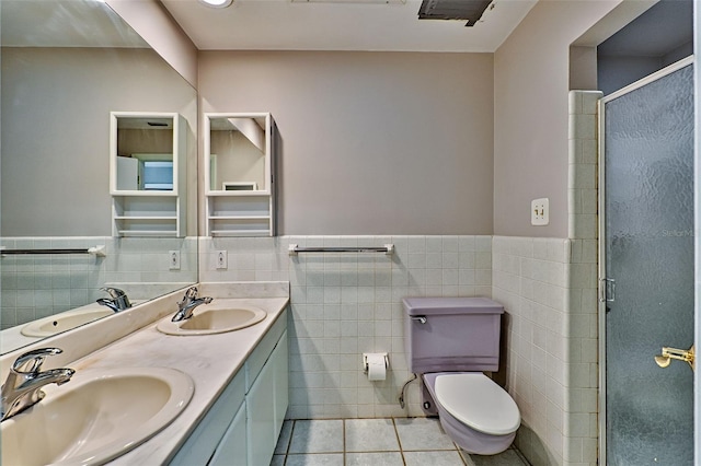 bathroom with a sink, toilet, and tile patterned flooring