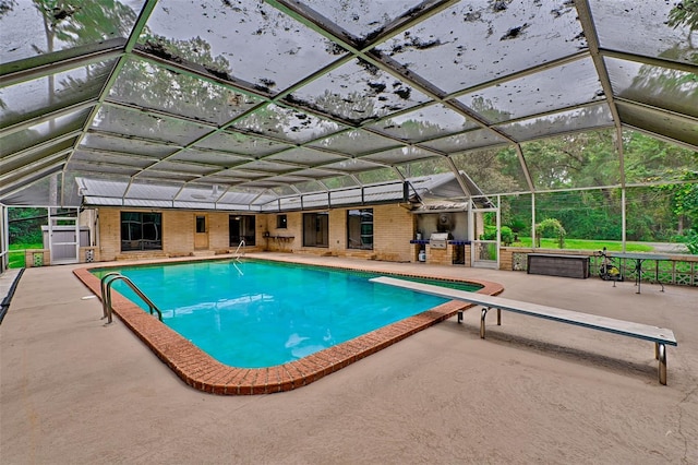 outdoor pool featuring glass enclosure and a patio