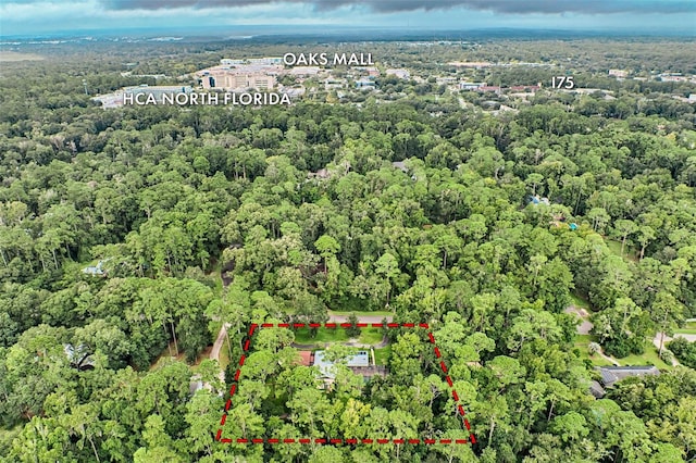 birds eye view of property featuring a view of trees