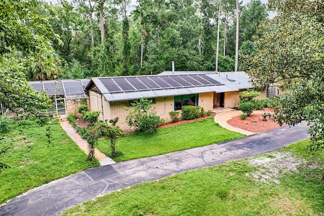 view of front of house with a front yard and brick siding