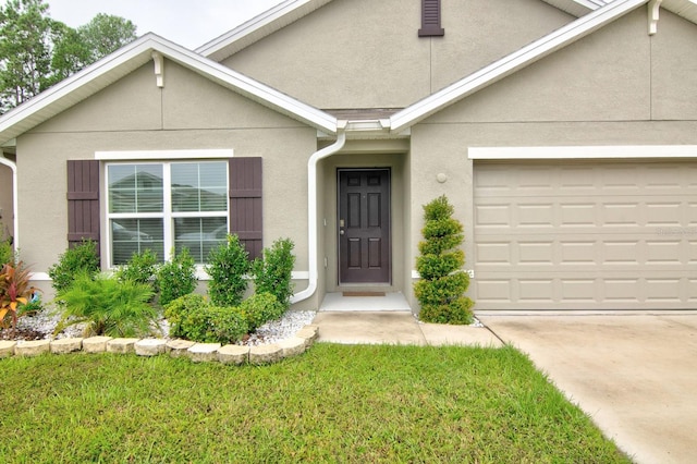 view of front of home featuring a garage and a front lawn