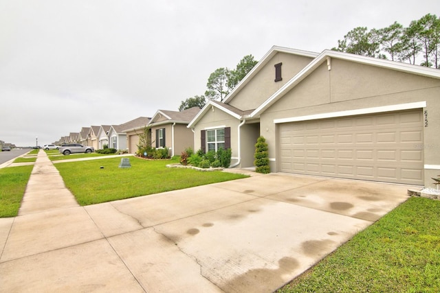 view of front of property with a garage and a front lawn