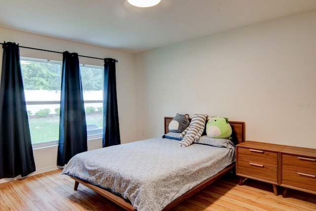 bedroom featuring light wood-type flooring and multiple windows