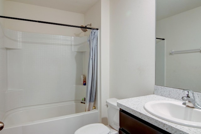 full bathroom featuring vanity, shower / bath combo with shower curtain, and toilet