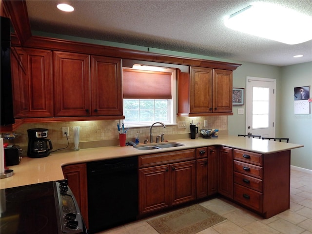 kitchen with backsplash, sink, black dishwasher, kitchen peninsula, and stove