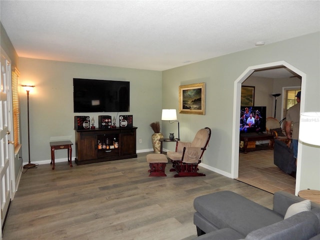 living room featuring a textured ceiling and hardwood / wood-style floors