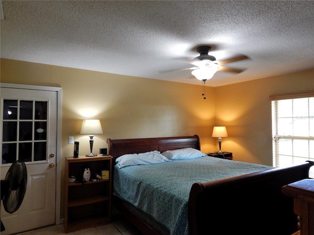 bedroom with a textured ceiling and ceiling fan