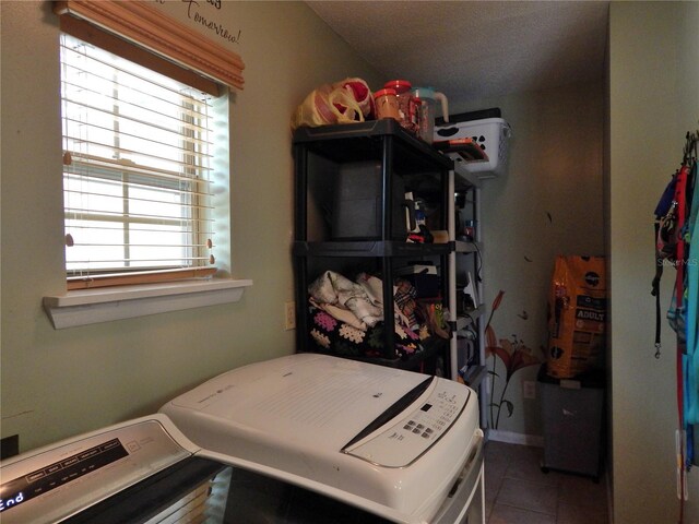 interior space with washing machine and clothes dryer and tile patterned flooring