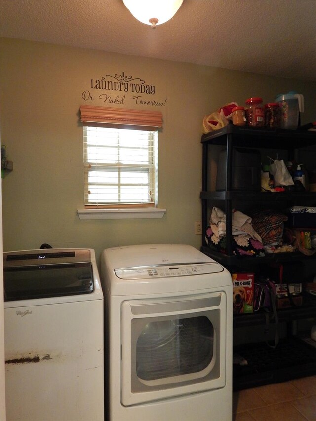 washroom featuring a textured ceiling, separate washer and dryer, and tile patterned floors