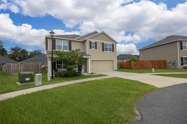 view of front facade with a garage, central AC, and a front yard