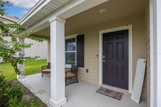 view of exterior entry featuring a porch