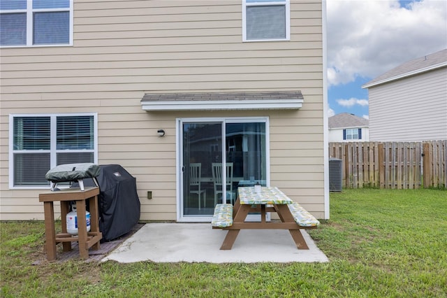 rear view of property with a lawn and a patio