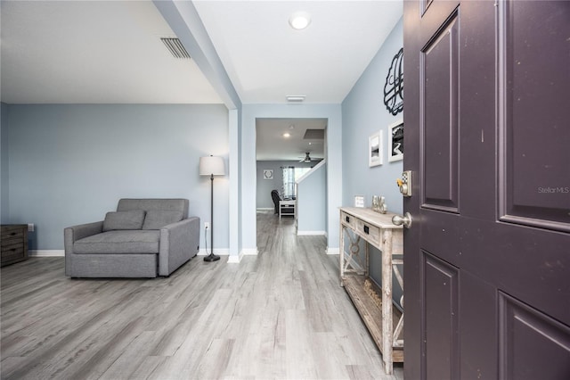 corridor with light hardwood / wood-style floors