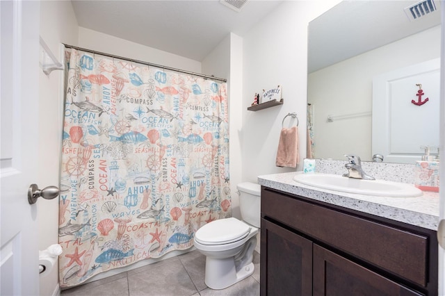 bathroom featuring curtained shower, vanity, toilet, and tile patterned floors