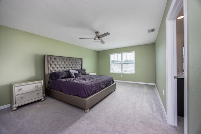 bedroom with carpet, ceiling fan, and a textured ceiling