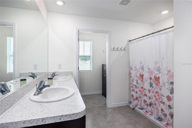 bathroom with vanity, a shower with shower curtain, and tile patterned floors