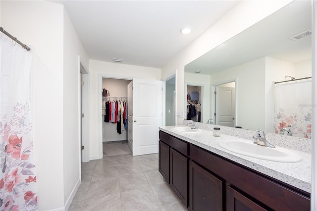 bathroom with tile patterned flooring, vanity, and a shower with curtain