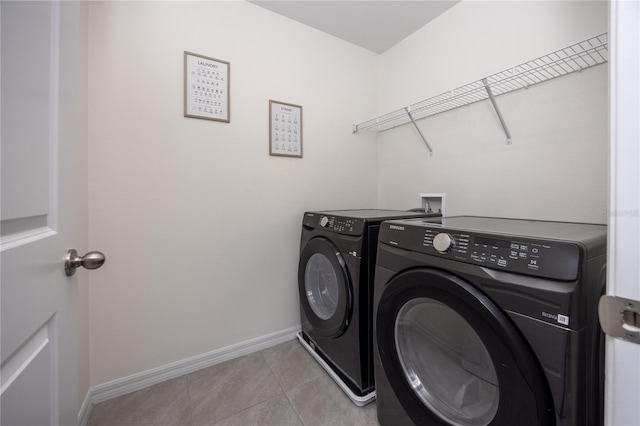 washroom with separate washer and dryer and light tile patterned floors