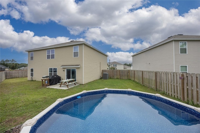 view of pool with a lawn, a patio area, grilling area, and central air condition unit