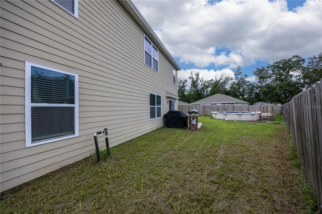 view of yard with a fenced in pool