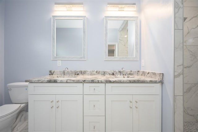 bathroom featuring vanity, a tile shower, and toilet