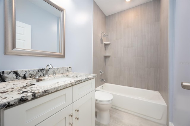 full bathroom featuring toilet, tiled shower / bath, vanity, and tile patterned floors