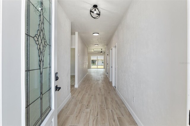 corridor with light wood-type flooring