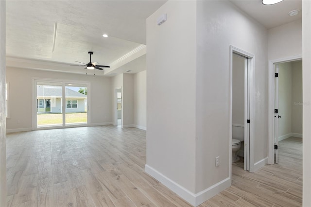 interior space featuring light hardwood / wood-style flooring and a tray ceiling