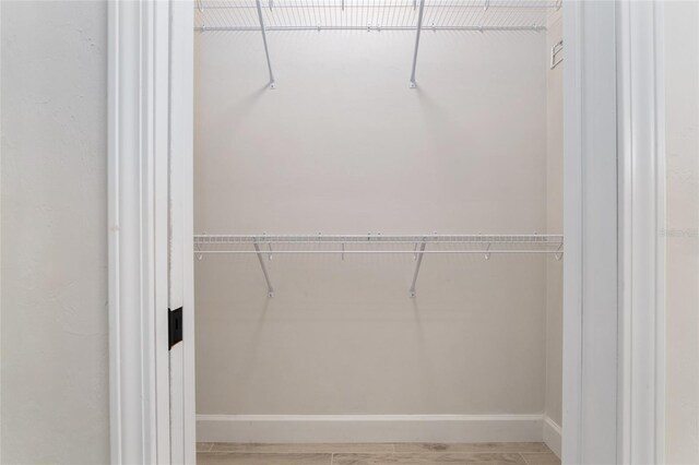 walk in closet featuring hardwood / wood-style flooring