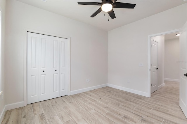 unfurnished bedroom with a closet, light hardwood / wood-style floors, and ceiling fan