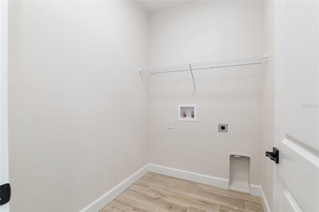 laundry area with light hardwood / wood-style floors, electric dryer hookup, and hookup for a washing machine