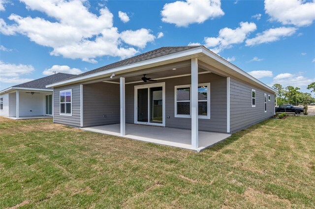 rear view of house with a patio, ceiling fan, and a yard